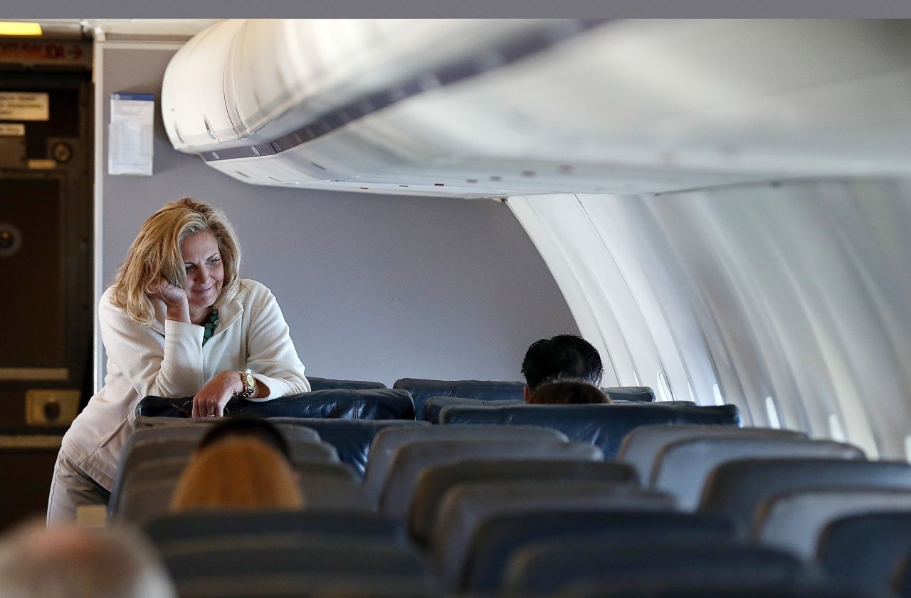 Ann Romney leans on a seat aboard the campaign plane en route to Tampa.