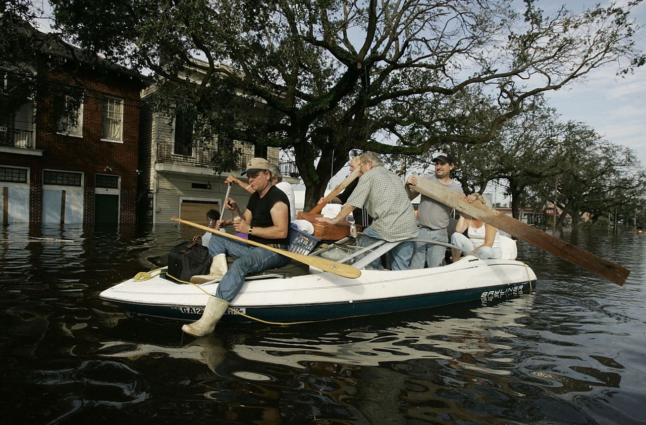 People try to get to higher ground as water rises on August 30, 2005, in New Orleans.
