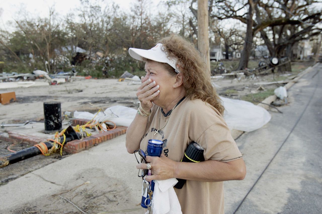 A woman cries after returning to her house and business, destroyed by Hurricane Katrina, on August 30, 2005, in Biloxi, Mississippi. 