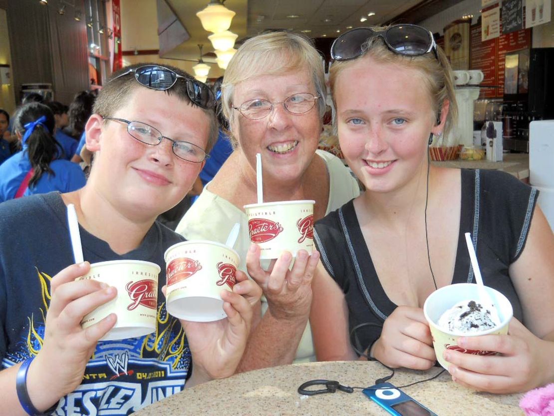 Sheila Evans and grandchildren Camron, left, and Rosa, right, dig into ice cream in Cincinnati, Ohio, where Evans picked Camron up for his week's vacation with her in Michigan.
