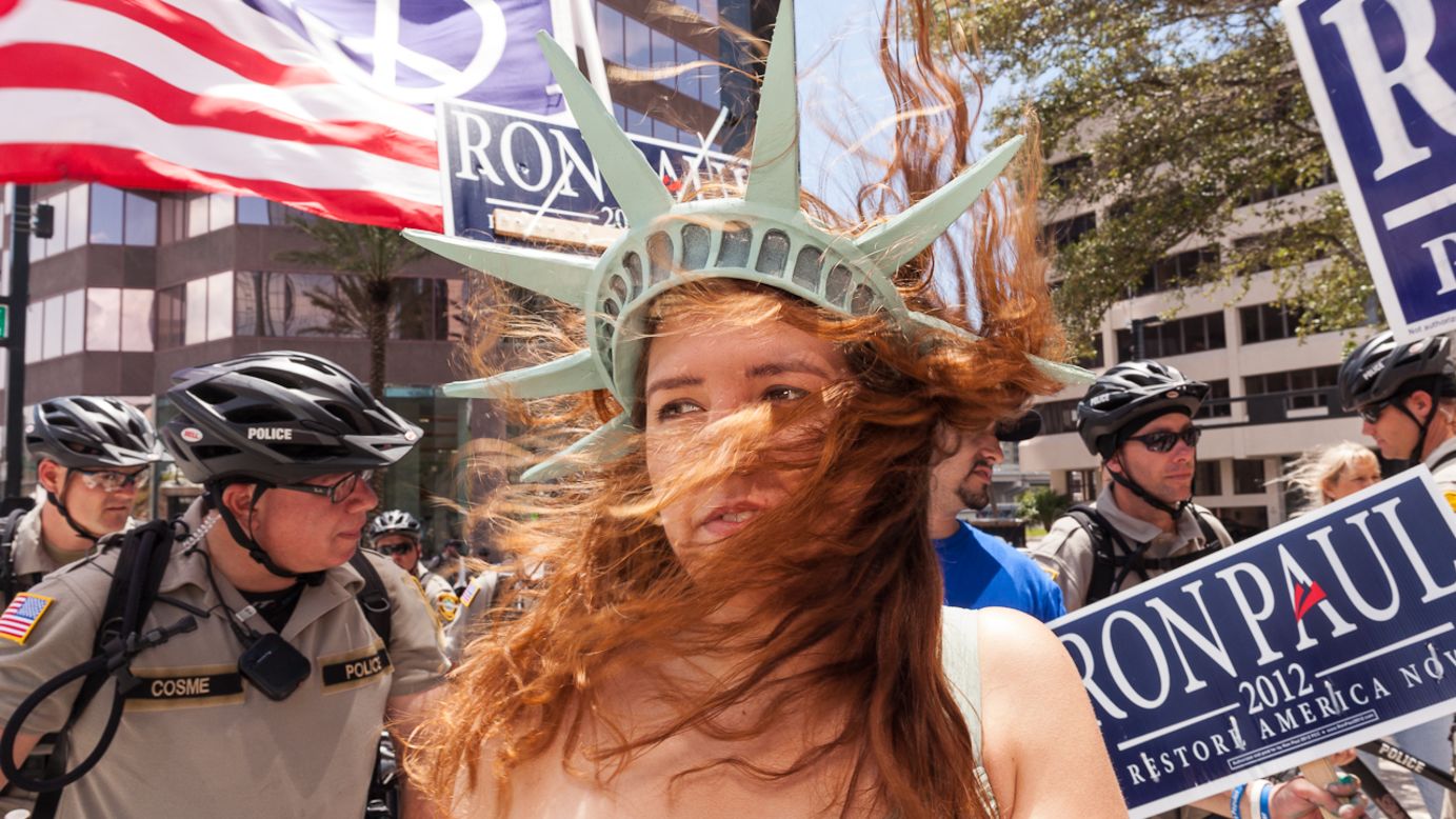 Jaclyn Tupek wears a Lady Liberty hat at a Ron Paul gathering a few blocks from the Tampa Bay Times Forum.