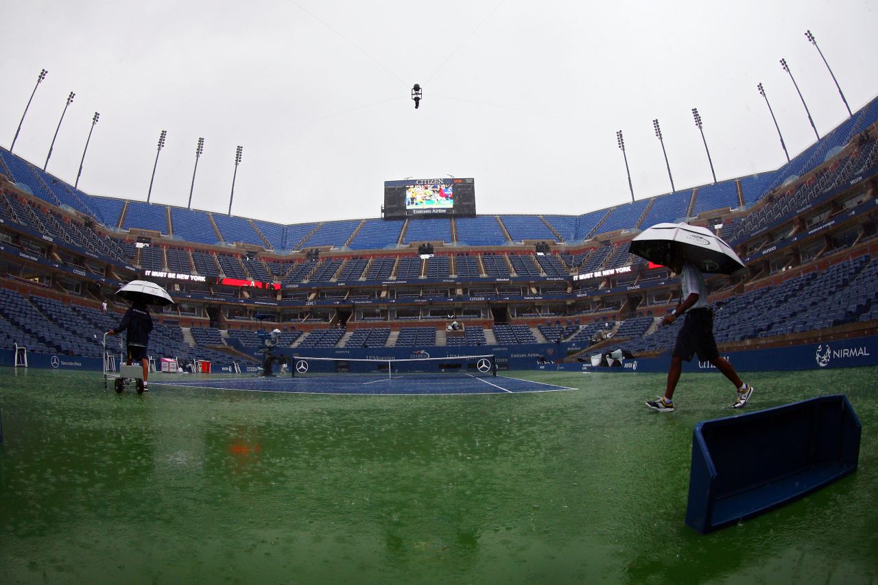 A downpour interrupts play Monday at Flushing Meadows.