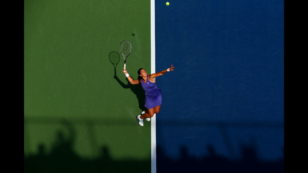 France's Marion Bartoli serves during her women's singles first-round match against American Jamie Hampton.