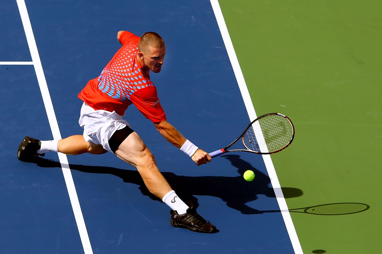 Russian Alex Bogomolov Jr. stretches to play a backhand against Andy Murray of Great Britain during their men's singles first-round match.
