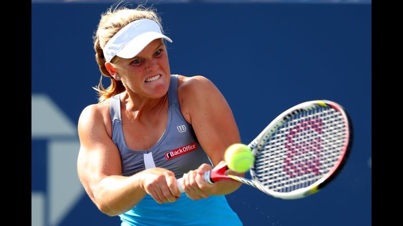 American Melanie Oudin returns a shot during her women's singles first-round match against Lucie Safarova of the Czech Republic.