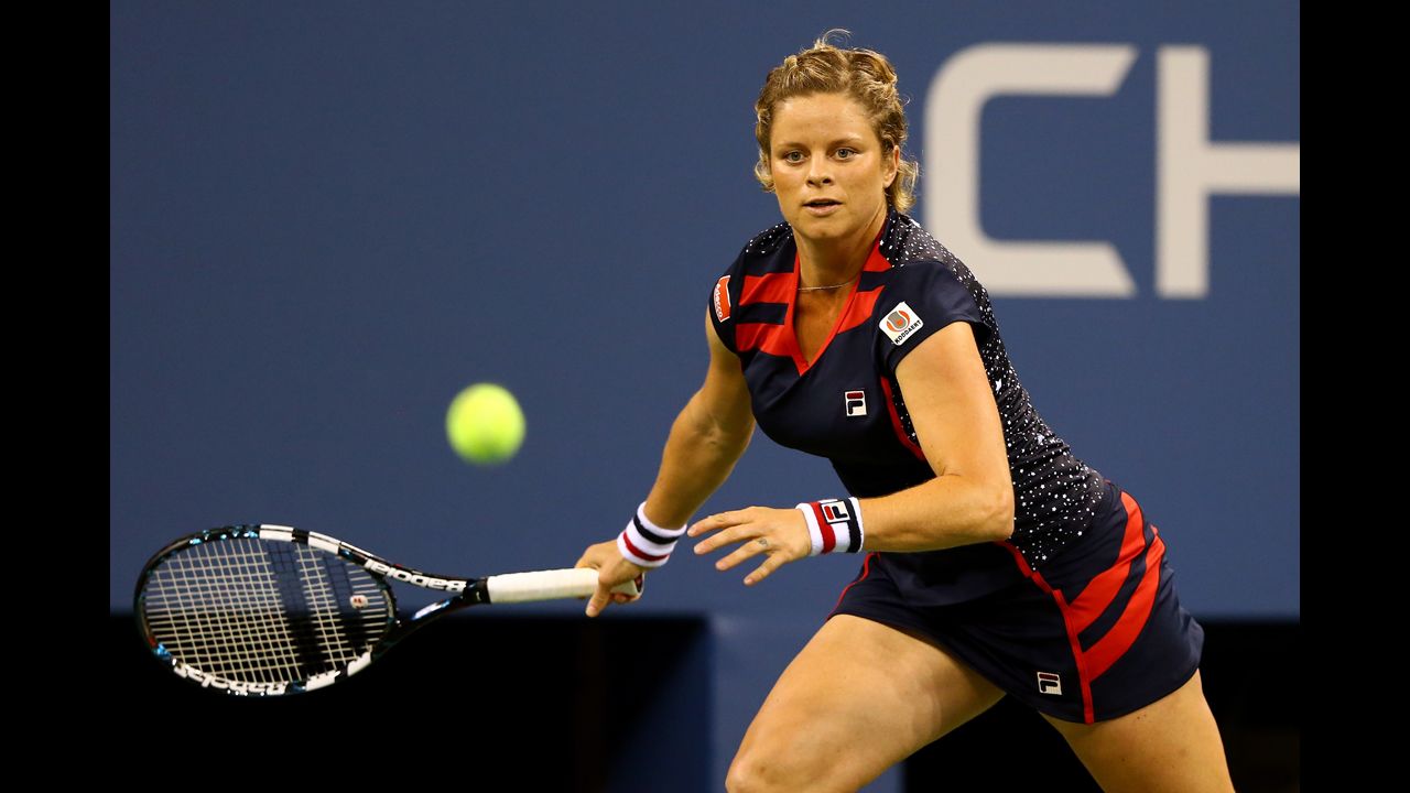 Belgium's Kim Clijsters moves to return a shot during her women's singles first-round match against American Victoria Duval.