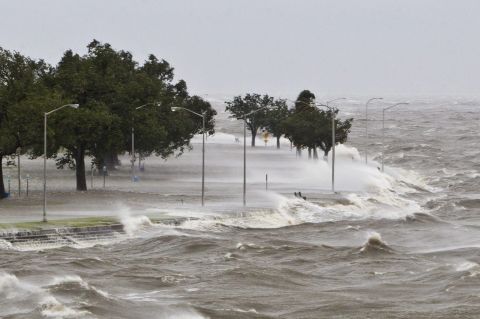 A storm surge causes water to quickly rise while waves pound the concrete seawall along the shores of Lake Pontchartrain in New Orleans on Tuesday, August 28.