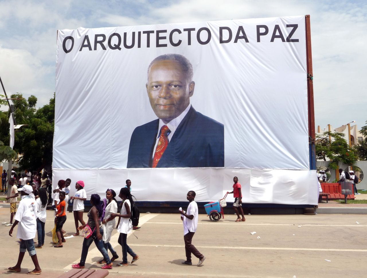 Earlier this year, Angola celebrated 10 years of the end of its civil war. Here, Luanda residents walk in front of a giant portrait of President  dos Santos, with text reading "The Architect of Peace" on April 4, 2012.