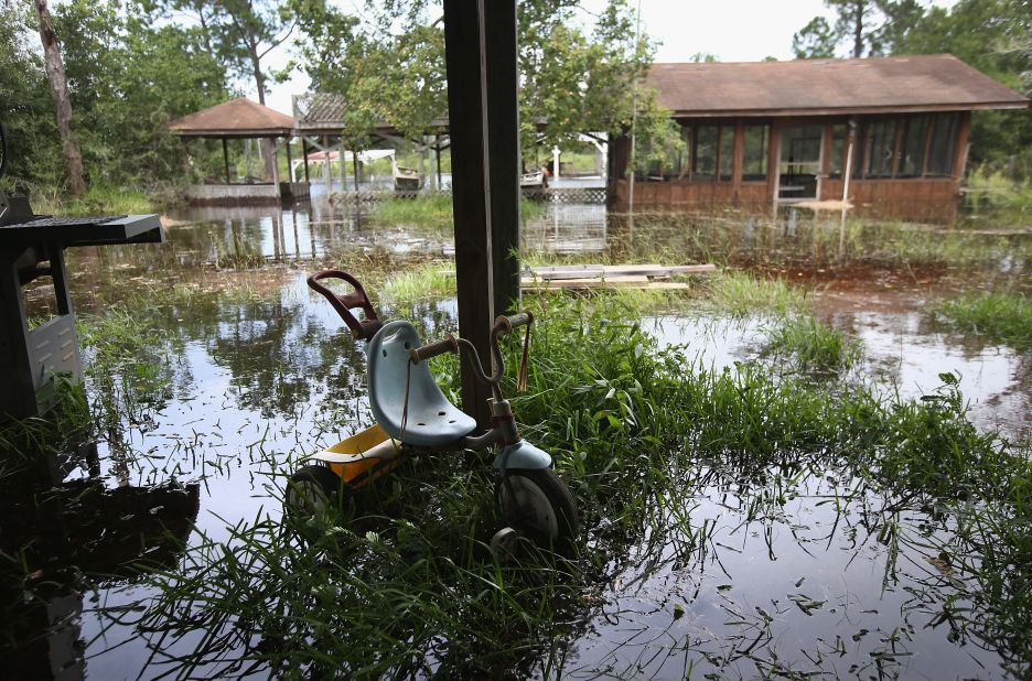 Water rises from a bayou, flooding properties ahead of the arrival of Hurricane Isaac in Bay St. Louis, Mississippi. 