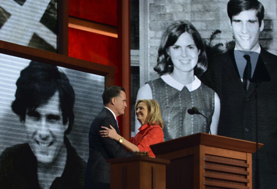 As the crowd cheers, Mitt Romney embraces his wife, Ann, on stage during the convention.
