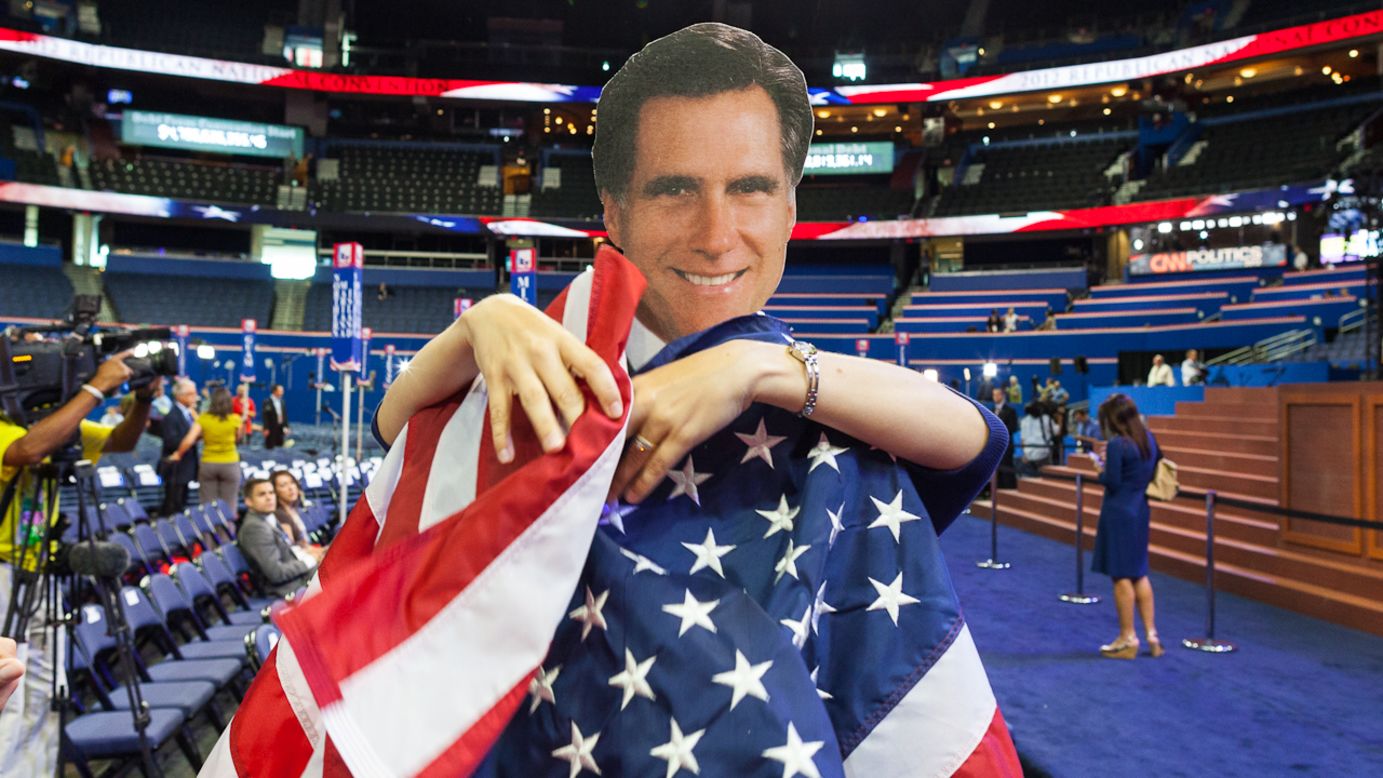 A Romney cutout is wrapped with the American flag on the floor of the convention.