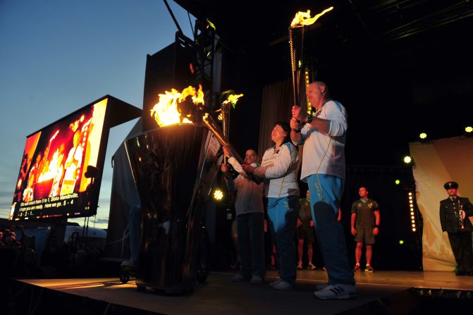 The cauldron is lit as the four Paralympic flames, which were lit on the UK's highest peaks, are united at Stoke Mandeville Hospital during the torch relay on Tuesday, August 28, in Aylesbury, England.