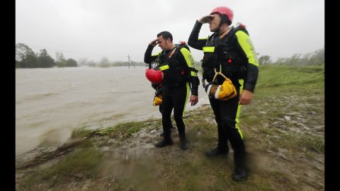 Rescue workers survey the floodwaters from a levee in Braithwaite. 