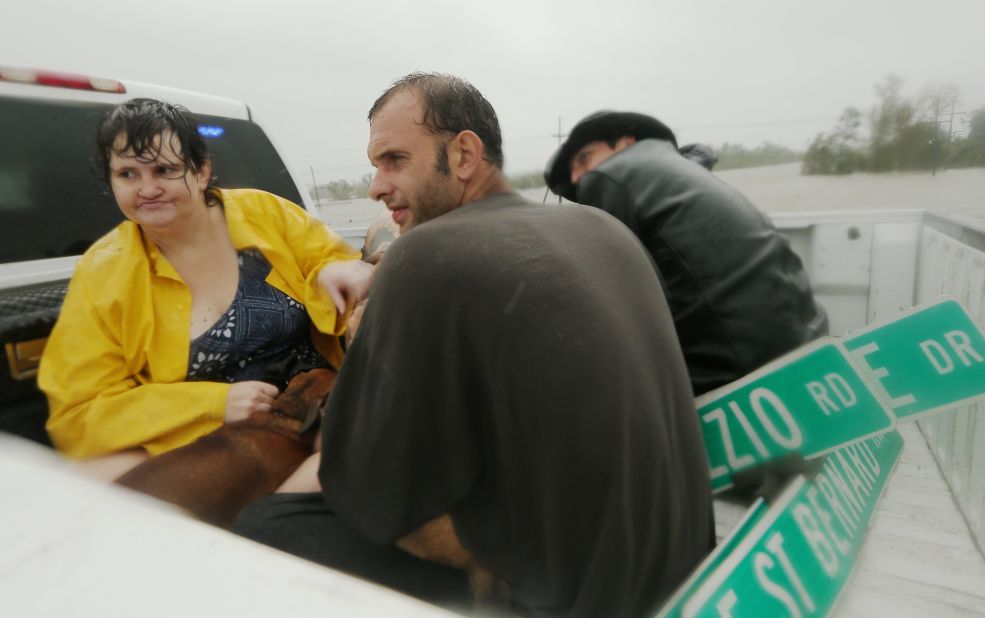 People rest in a rescue truck atop a levee in Plaquemines Parish.