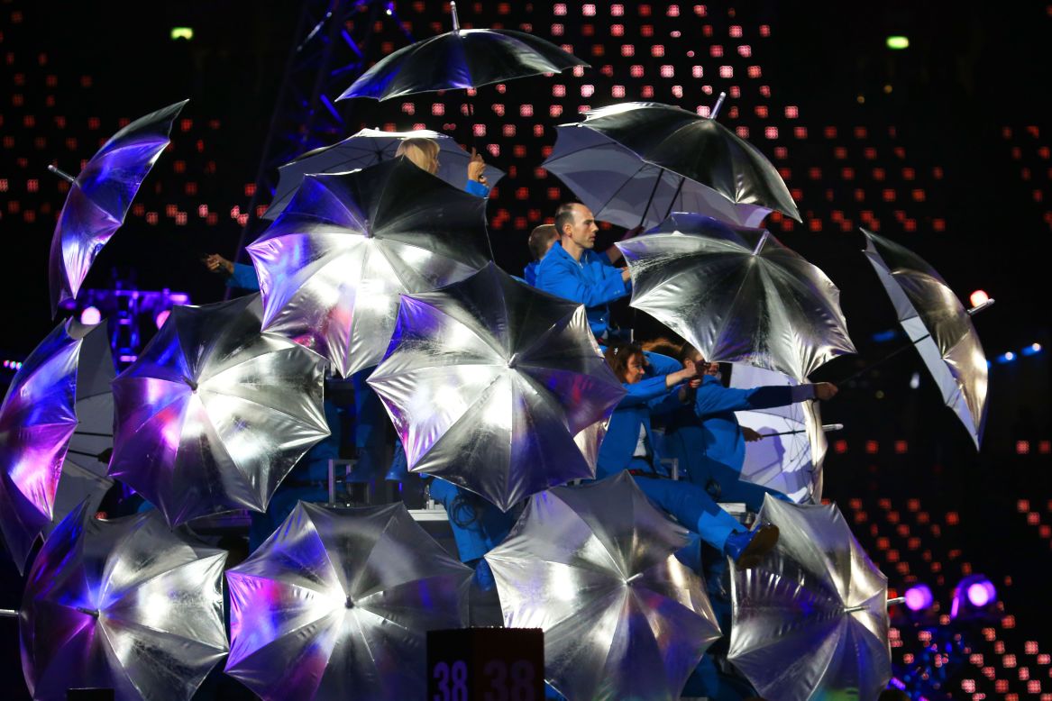 Artists brandished silver umbrellas during their performance.