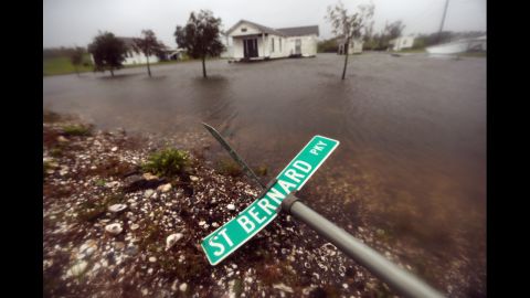 A street sign lies near floodwaters fromIsaac on Wednesday, in Braithwaite, Louisiana. Dozens were reportedly rescued in the area after levees were overtopped by floodwaters from Hurricane Isaac.