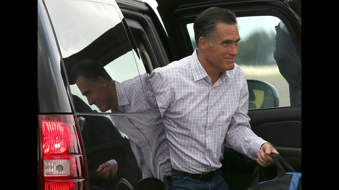 Republican presidential candidate Mitt Romney exits a vehicle before boarding his campaign plane. As the Republican National Convention continues, Romney will travel to Indianapolis to address the American Legion.  