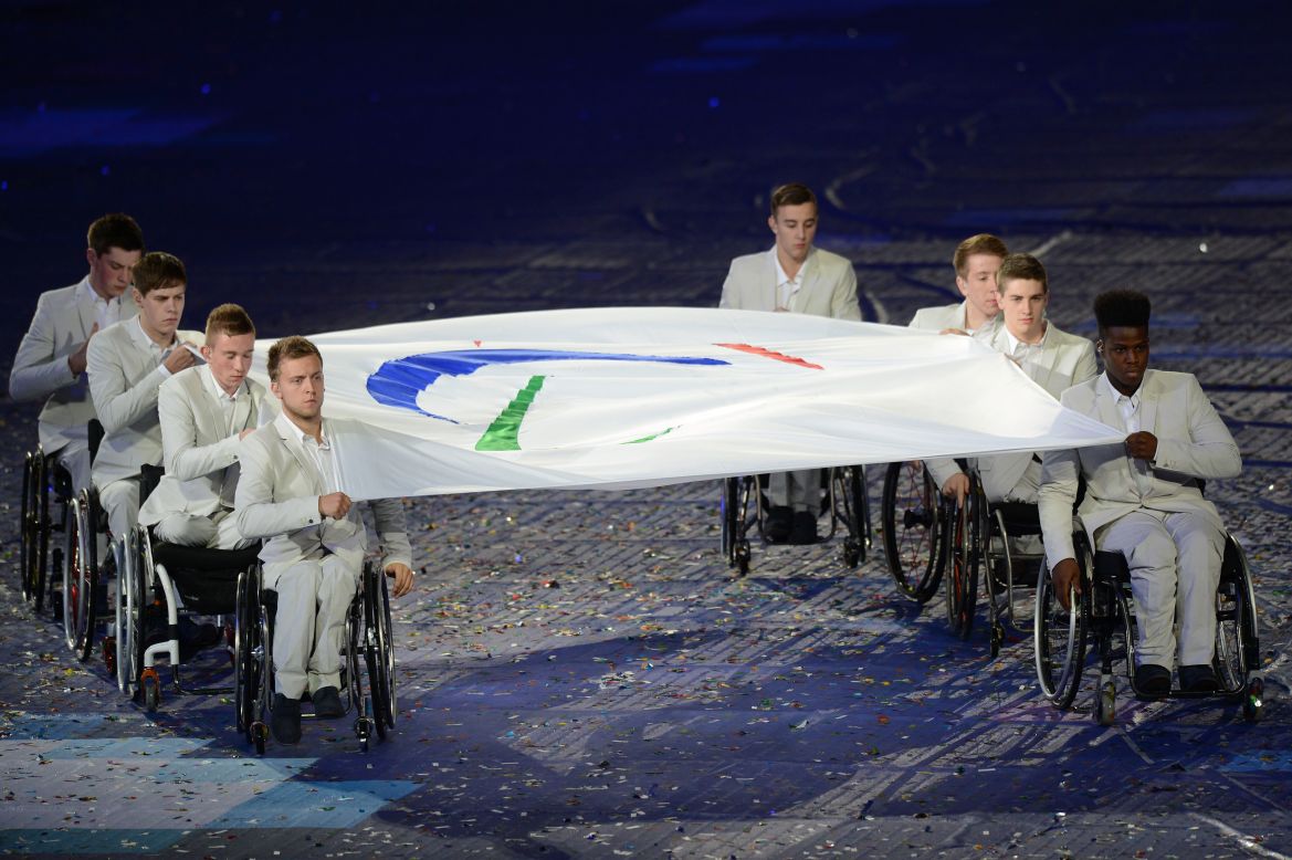 The Paralympic flag is carried by members of the Great Britain wheelchair basketball team.