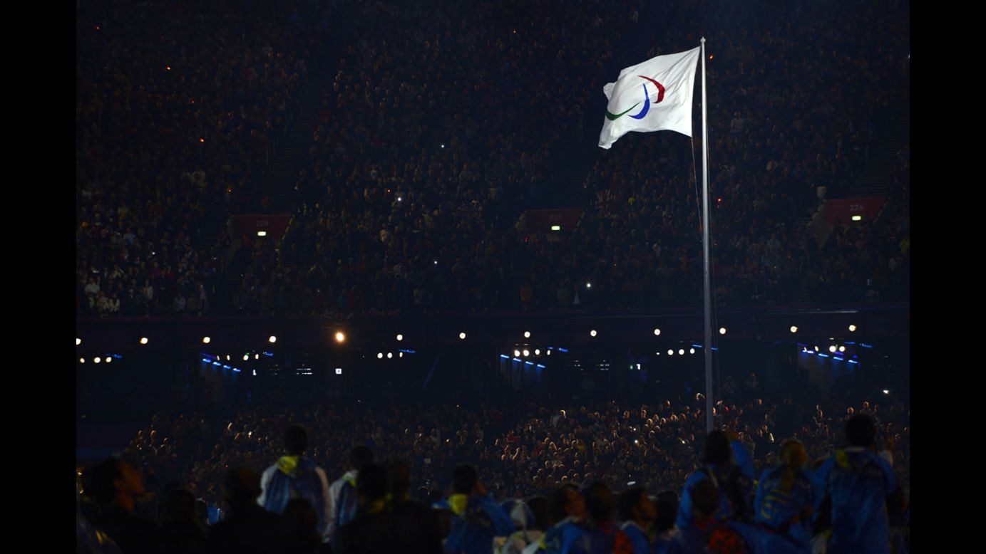 The Paralympic flag is raised.