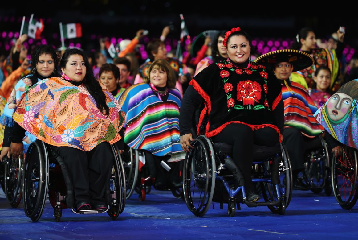 Athletes from Mexico parade in front of a cheering crowd.