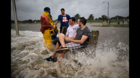  A group of men sit on a bench at the edge of Lake Pontchartrain as Hurricane Isaac approaches. 