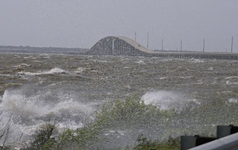 High surf splashes along Highway 193 north of the Dauphin Island Bridge in  Alabama.