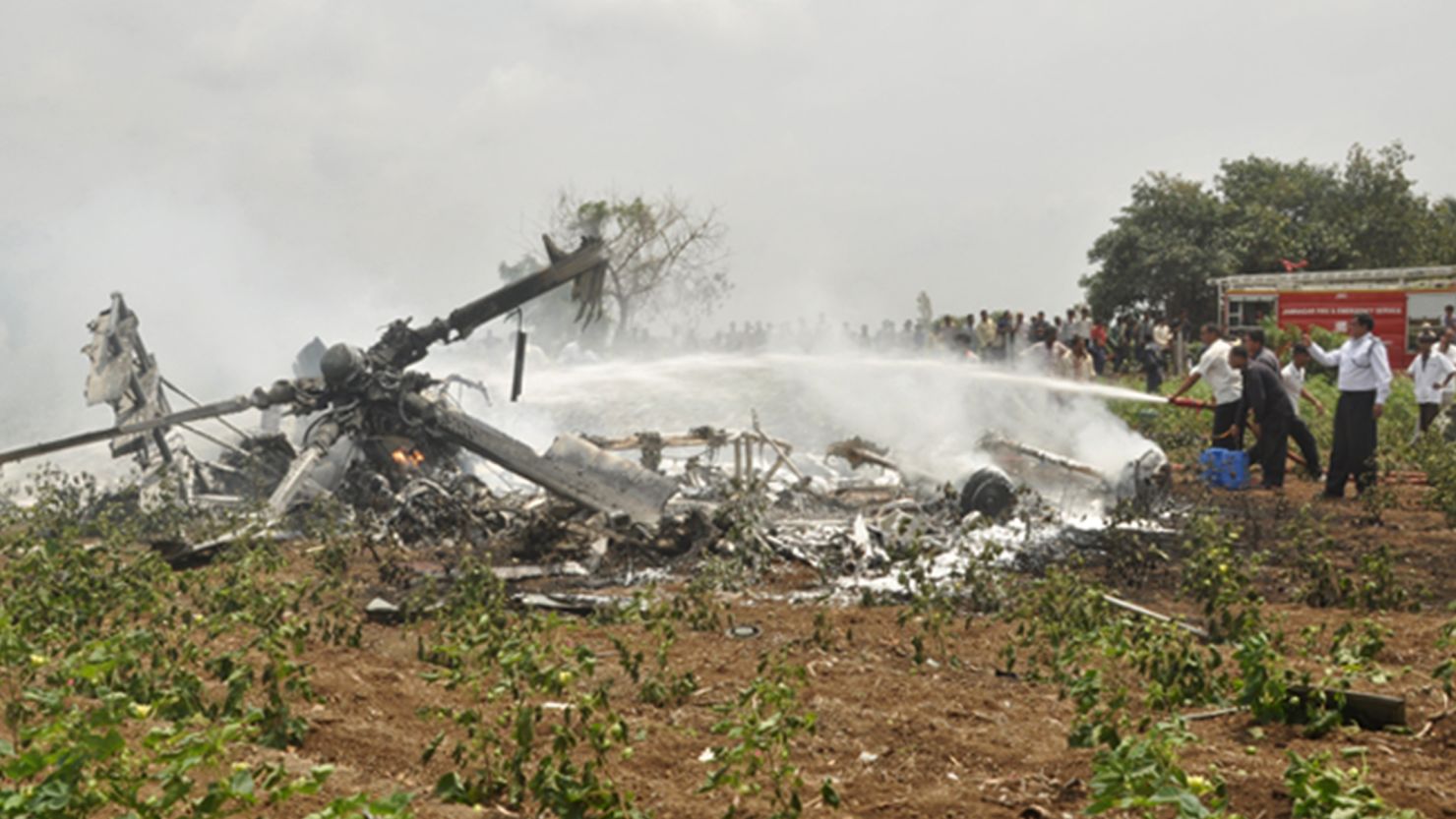 Indian rescue personnel douse the wreckage of one of two crashed Indian Air Force Mi-17 helicopters on August 30, 2012. 