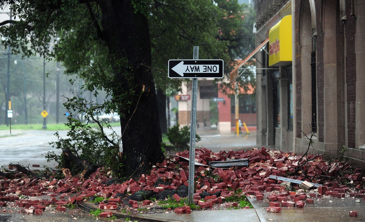 A street sign turned upside down, likely the result of bricks falling overnight from a building along the deserted streets of New Orleans.