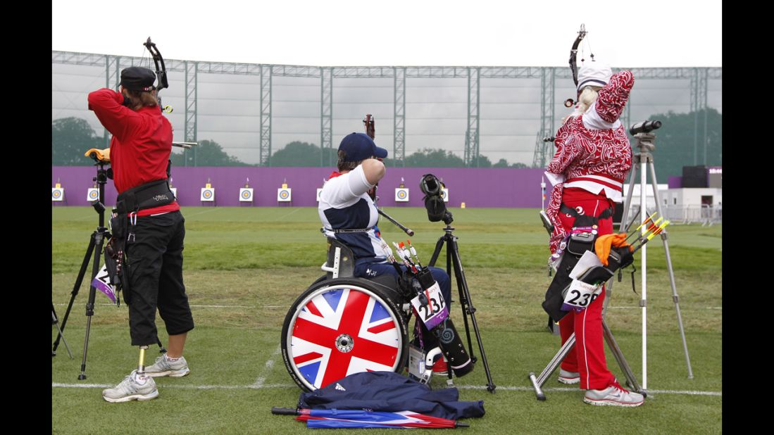 Britain's Mel Clarke, center, competes in the women's archery individual compound open ranking round.