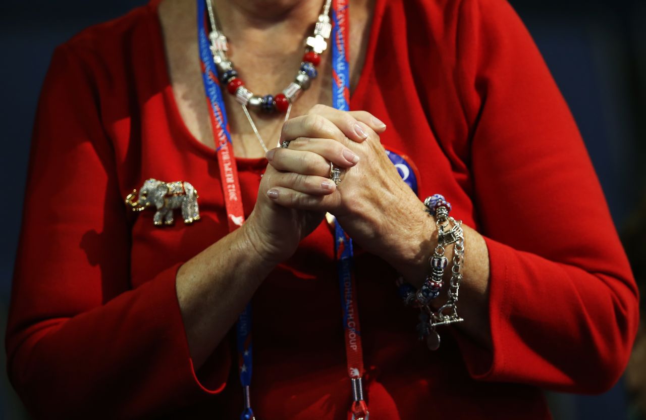A woman grasps her hands during speeches on the third day of the GOP convention.