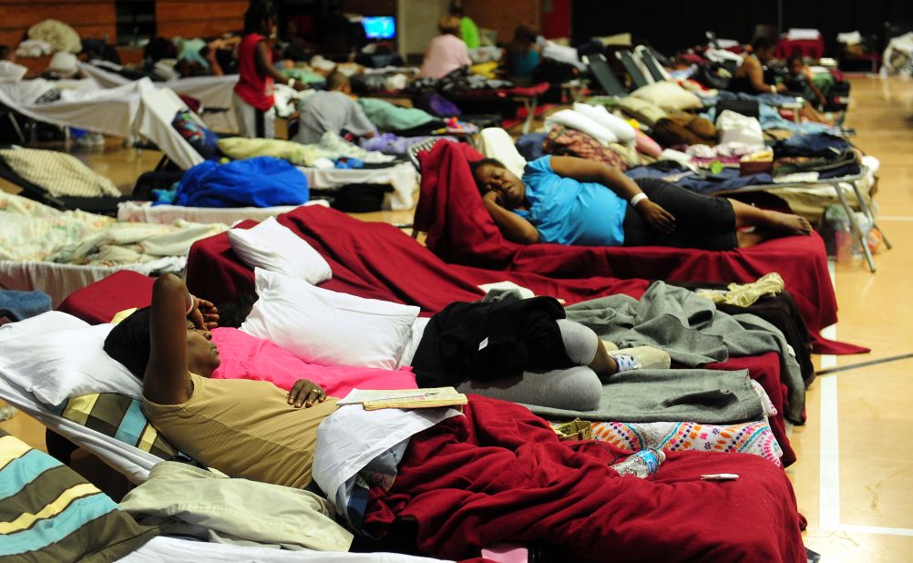 Storm-weary residents take refuge at a high school gymnasium in Belle Chasse, a low-lying area outside of New Orleans.