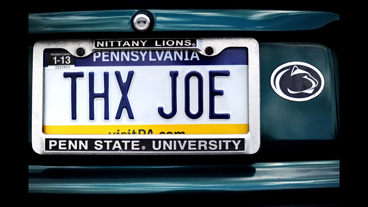A car parked in a garage on campus has a license plate message directed at the former Penn State football coach. 