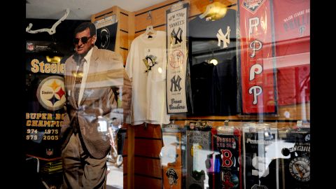 A Paterno cutout stands inside a storefront window on College Avenue.