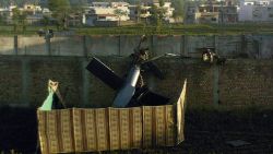 A crashed military helicopter is seen near the hideout of Al-Qaeda leader Osama bin Laden after a ground operation by US Special Forces in Abbottabad on May 2, 2011. Pakistan said that the killing of Osama bin Laden in a US operation was a 'major setback' for terrorist organisations and a 'major victory' in the country's fight against militancy. AFP PHOTO/str (Photo credit should read STR/AFP/Getty Images)