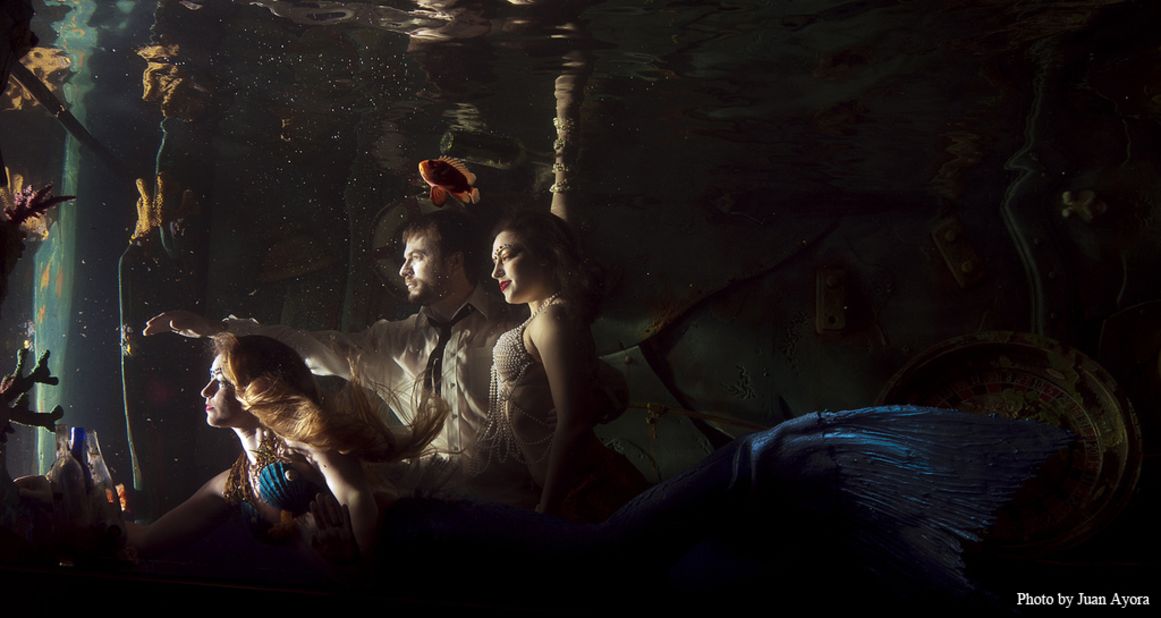 Mermaids swim in a huge aquarium above the bar at Sacramento's Dive Bar.