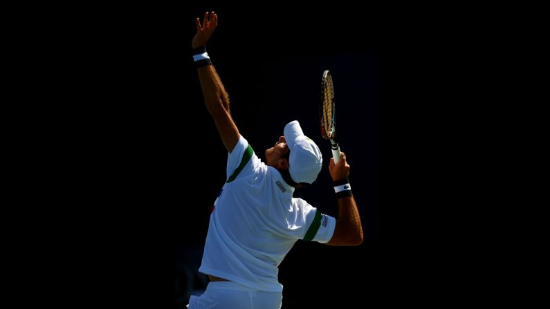 Pablo Andujar of Spain serves against Feliciano Lopez of Spain during their men's singles second-round match.