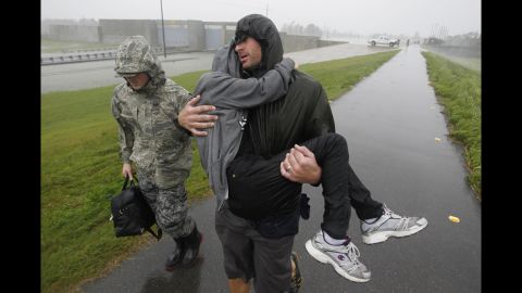 First responders carry people across the top of the levee from Plaquemines Parish to St. Bernard Parish.