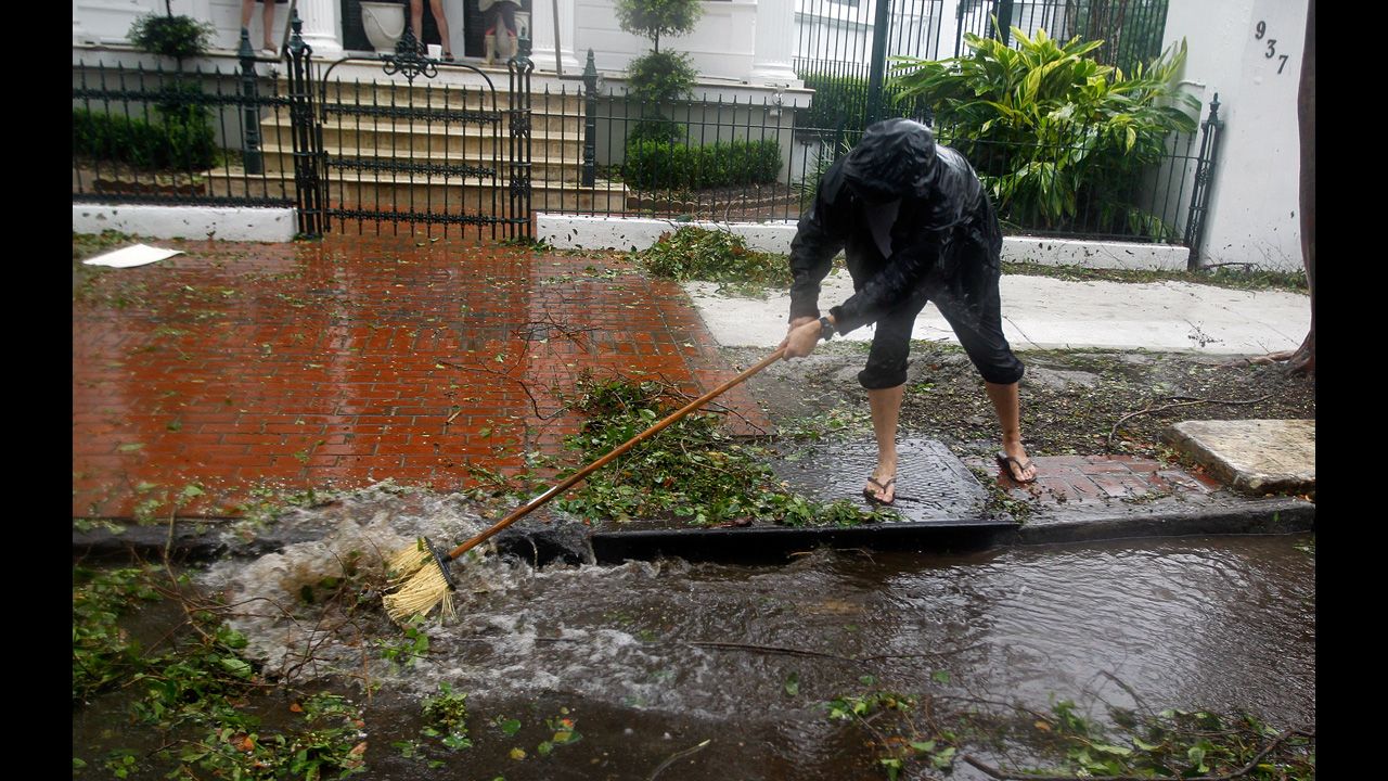 Mark Savoie cleans Espanade Avenue in New Orleans of tree debris to help the area near Burgundy drain as Isaac slowly moves inland.