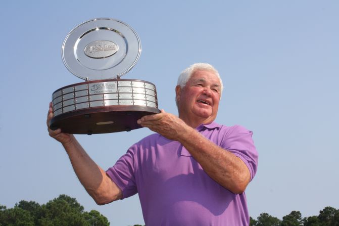 Last year's winner Bobby Perkinson proudly holds aloft the spoils of victory.