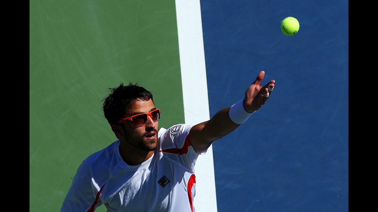 Serbian Janko Tipsarevic serves against Guillaume Rufin of France.