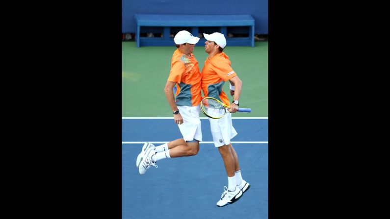 U.S. players Bob Bryan and Mike Bryan chest bump after winning match point in their men's doubles first-round match against Belgian players David Goffin and Steve Darcis.