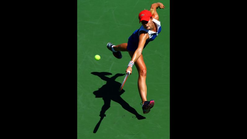 France's Alize Cornet returns a shot during her women's singles second-round match against Czech Petra Kvitova.