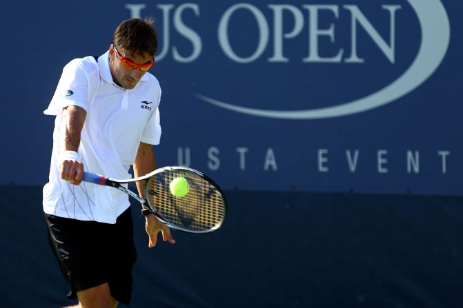 Spain's Tommy Robredo poaches the ball during his men's singles first-round match against Italian Andreas Seppi.