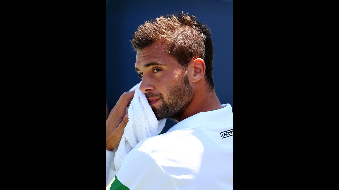 Benoit Paire of France wipes his face during his men's singles first-round match against Bulgarian Grigor Dimitrov.