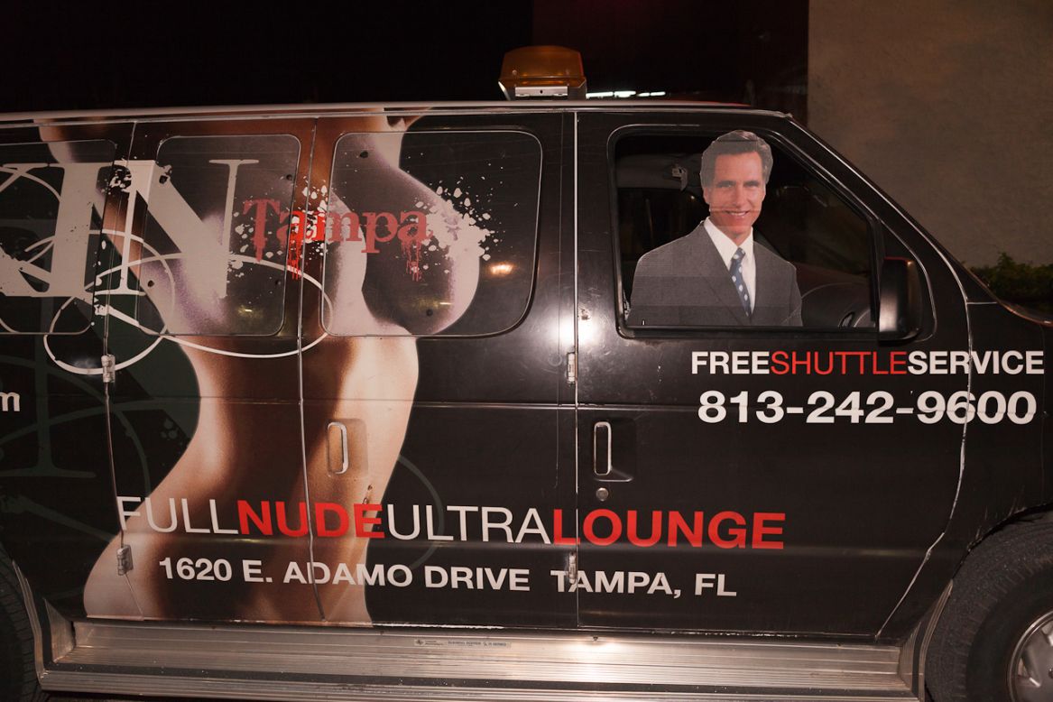 A Mitt Romney cutout rides in the front seat of a van advertising a "nude lounge" during the Republican National Convention on Thursday.