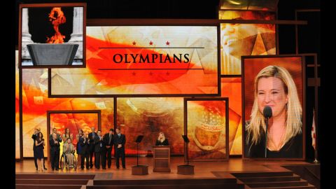 Olympians and gold medalists Michael Eruzione, Derek Parra and Kim Rhode stand on stage at the convention.