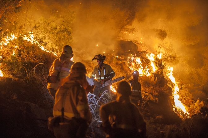 Members of a wildfire brigade try to extinguish a fire in Bedar, a town in the Almeria region of Spain on August 26, 2012. Wildfire has since spread further down the Spanish coast towards Marbella.