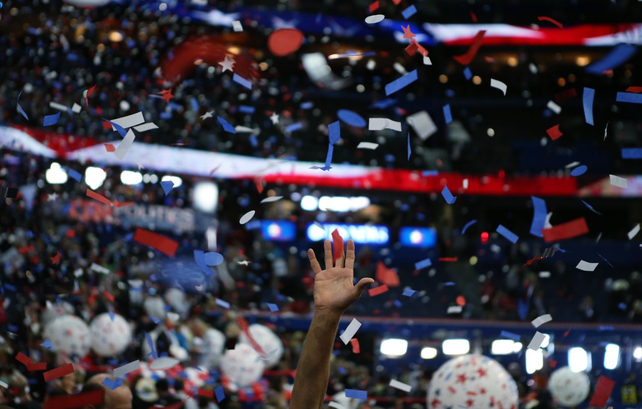 Attendees celebrate as confetti and balloons drop after Romney's speech.