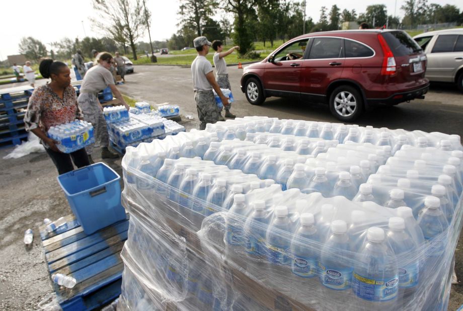 Members of the Louisiana Army National Guard and Louisiana Air National Guard distribute water, MREs and ice at Skelly-Rupp Stadium in New Orleans on Friday.