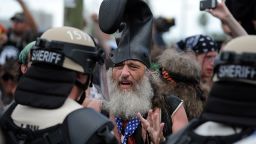 Protester Vermin Supreme talks with riot police at the Republican National Convention in Tampa on Tuesday, August 28.